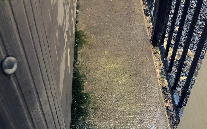 Before pressure washing concrete deck in Southern Oregon
