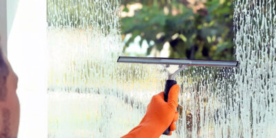 A professional cleaning a window in Southern Oregon