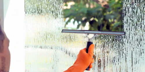 A professional cleaning a window in Southern Oregon